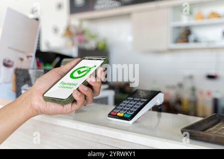 Customer using phone for payment at cafe restaurant, cashless technology and money transfer concept. QR code payment, customer using smartphone for pa Stock Photo