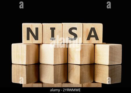 Nippon Individual Savings Account, the word NISA made of wooden cubes on a black background. Stock Photo