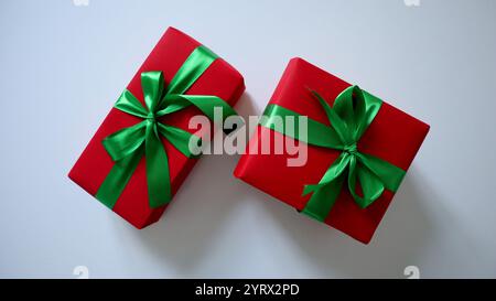 A set of two gifts. Rectangular and square boxes. Red wrapping paper. Green ribbons and bows. Isolated on white background. Traditional Christmas colo Stock Photo