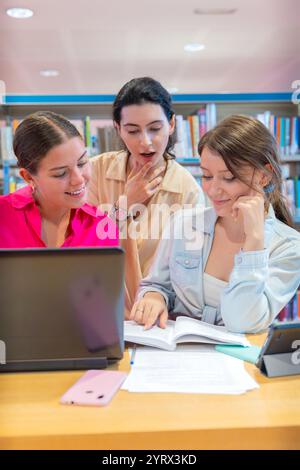 Group of students collaborating on a project in a library.Vertical Stock Photo
