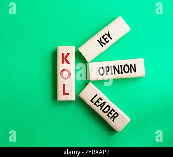 KOL - Key Opinion Leader symbol. Concept word KOL on wooden blocks. Beautiful green background. Business and KOL concept. Copy space. Stock Photo