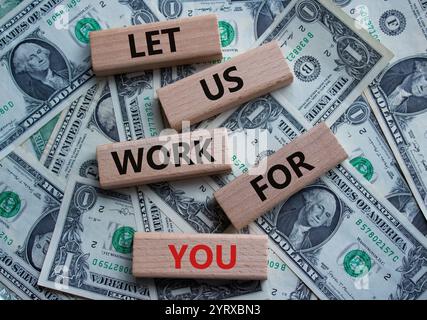 Let us work for you symbol. Wooden blocks with words Let us work for you. Beautiful dollar background. Business and Let us work for you concept. Copy Stock Photo