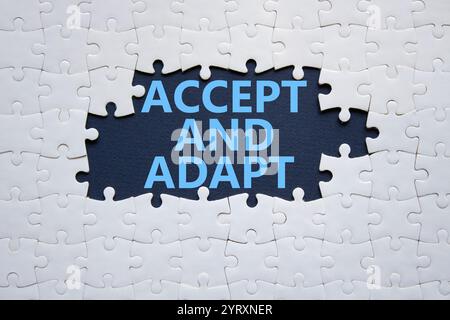 Accept or adapt symbol. Concept words Accept and adapt on white puzzle. Beautiful deep blue background. Business and Accept and adapt concept. Copy sp Stock Photo