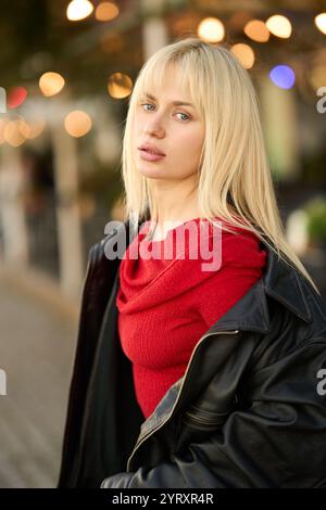 Blonde ukrainian model posing in red and black outdoors photoshoot Stock Photo