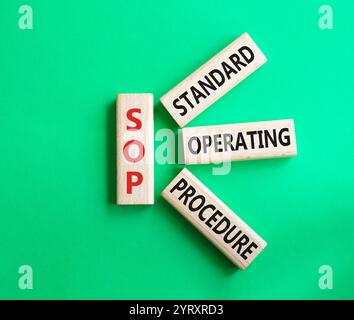 SOP - Standard Operating Procedure symbol. Wooden blocks with word SOP. Beautiful green background. Business and SOP concept. Copy space. Stock Photo