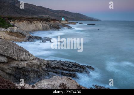 Waves crash against the rocky shore of Leo Carrillo State Beach in Malibu, California, showcasing the beauty of Southern California's coastline. Stock Photo