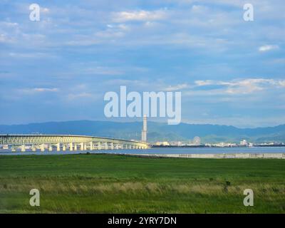 Looking out from Runway 24L of Kansai International Airport in Osaka, you can see the Sky Gate Bridge R (Kansai International Airport Access Bridge) and the Rinku Gate Tower Building. Stock Photo