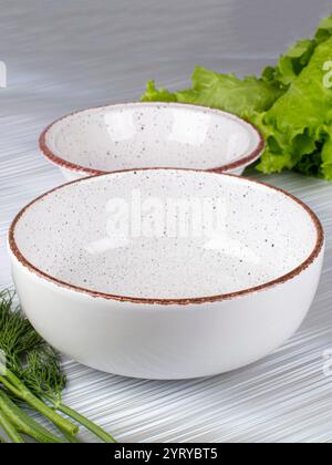 Ceramic clay plate with dark edging on gray background Stock Photo