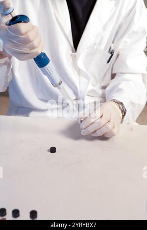 Scientist carefully handling samples in laboratory setting, conducting scientific research using micropipette and eppendorf tubes Stock Photo