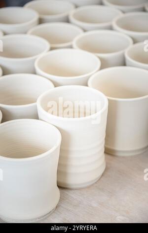 Hands shaping clay on a pottery wheel, highlighting traditional craftsmanship, ceramic art, and artisanal pottery making. Stock Photo