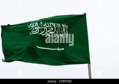 The national flag of Saudi Arabia is waving against the sky. Stock Photo