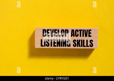 Develop active listening skills message written on ripped torn yellow ...