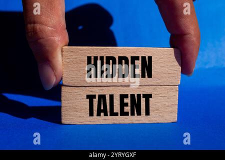 Hidden talent message written on wooden blocks with blue background. Conceptual hidden talent symbol. Copy space. Stock Photo