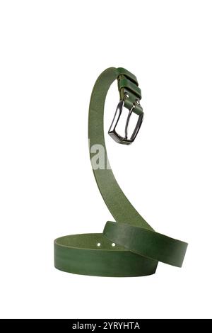 The green leather belt with a metal buckle is beautifully curved and isolated on a white background. Stock Photo