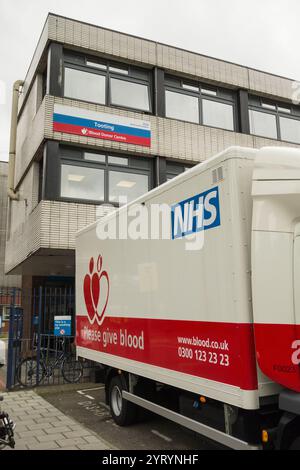 A NHS Please Give Blood mobile donation centre lorry parked outside St George's Hospital, Tooting, London, SW18. Stock Photo