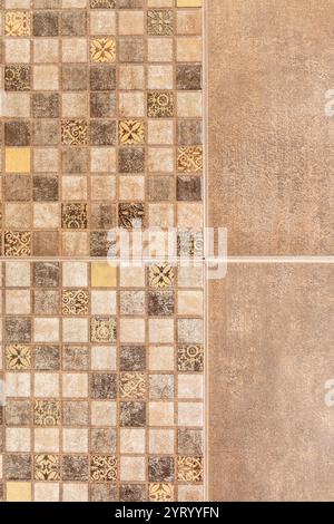 Close-up shot of wall tiled with small and big beige mosaic squares, bathroom or kitchen design Stock Photo