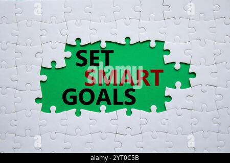 Set smart goals symbol. Concept words Set smart goals on white puzzle. Beautiful green background. Business and Set smart goals concept. Copy space. Stock Photo
