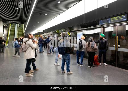 Passengers board an Elizabeth Line train at the new Whitechapel Station ...