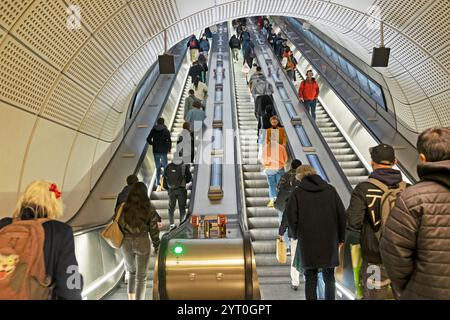 Passengers people standing riding on Elizabeth Line escalator at Whitechapel underground tube station in East London England UK 2024  KATHY DEWITT Stock Photo