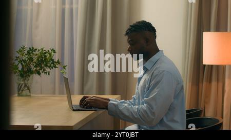 Pensive African American man think idea thinking ponder solution ethnic male biracial guy student business freelancer businessman at evening at home Stock Photo