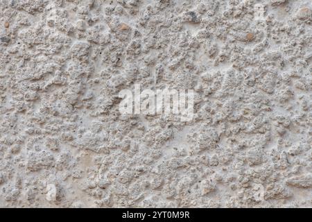 Texture of lumpy concrete surface.Rough surface of concrete slab, visible structure of concrete consisting of sand, pebbles of different sizes. Stock Photo