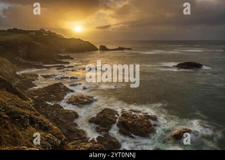 Sunrise over Lizard Point across Polpeor Cove, Cornwall, England.  Autumn (September) 2024. Stock Photo