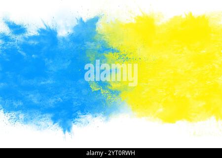 Acrylic dry paint splatter explosion of blue and yellow paint on a white background. Mixing colors. Splashes of paint, creative Stock Photo