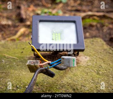 Sochi, Russia - March 16, 2024: LED street lighting floodlight connected to cable with terminals Stock Photo