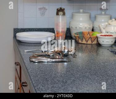 plates and dinnerware ready to be placed on the dining room table Stock Photo