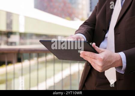 close up of unrecognizable man browsing tablet Stock Photo