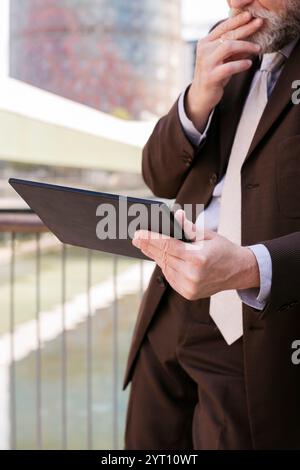 close up of unrecognizable man browsing tablet Stock Photo