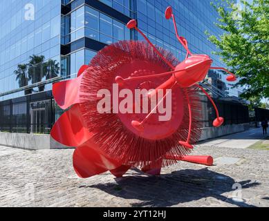 Giant red metal Passion Flower sculpture by Marcela Cabutti on the Puerto Madero waterfront in Buenos Aires Argentina Stock Photo