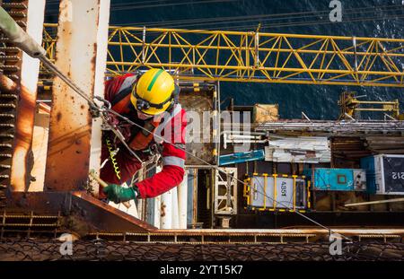 Rope access worker on oil rig abseiling on rope Stock Photo - Alamy