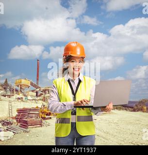 Female asian engineer working on a laptop computer at a construction site Stock Photo