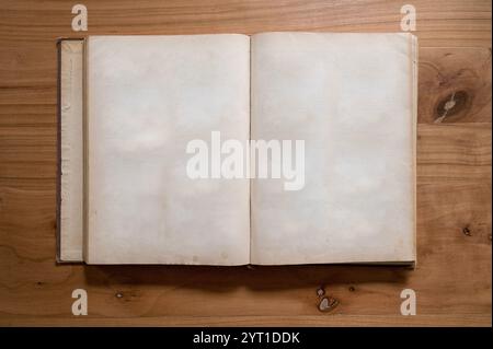 Old Open Empty Blank Book Sheets, Damaged Weathered Book on Wooden Table Stock Photo