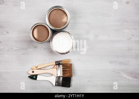 Artistic setup with open paint cans and brushes on a wooden surface Stock Photo