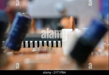 Partial view of an Integrated Circuit or IC on an electronic board. Focused on pins of semiconductor component. Stock Photo