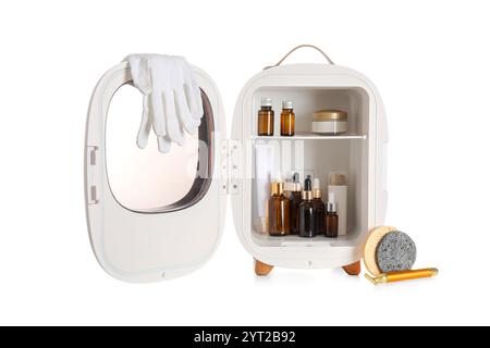 Small cosmetic refrigerator with cosmetic products on white background Stock Photo