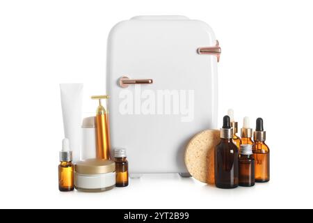 Small cosmetic refrigerator and cosmetic products on white background Stock Photo
