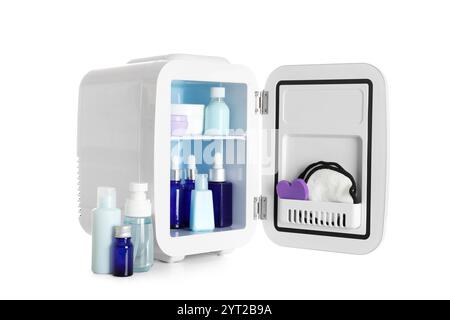 Small cosmetic refrigerator with cosmetic products on white background Stock Photo