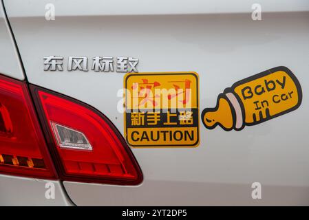 English warning 'baby in car' at chinese car in Beijing, China Stock Photo