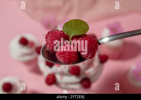 Frozen raspberries in the tee spoon with mentha. Decoration of the food Stock Photo