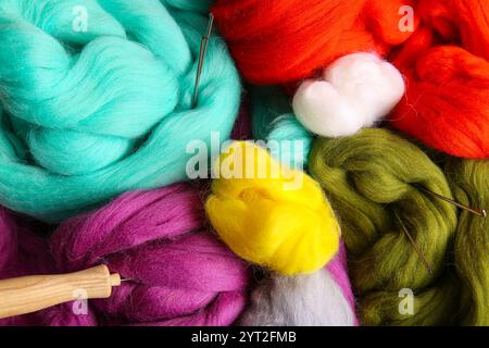 Different wool for felting with needles as background, closeup Stock Photo