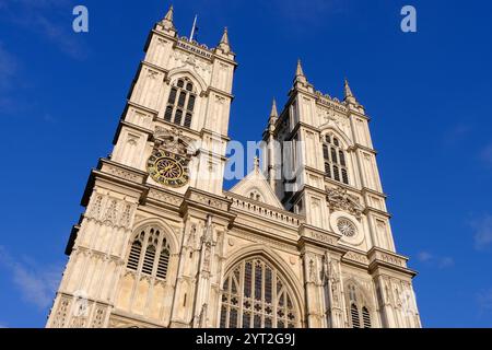 Westminster Abbey west façade towers against a blue sky in London, England, UK Stock Photo