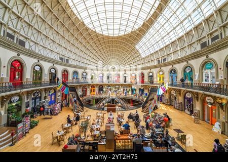 Inside Leeds city Corn Exchange shopping mall. Interior panorama of Leeds UK Corn Exchange mall, market with restaurants, cafes, shops in city center. Stock Photo