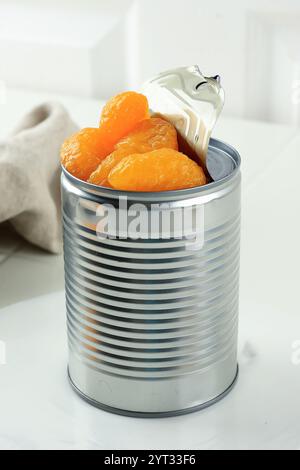Closeup of an Opened Can of Mandarin Oranges on White Background Stock Photo