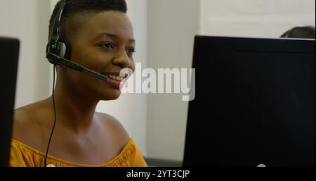 Business executives working with headset on desk in office Stock Photo