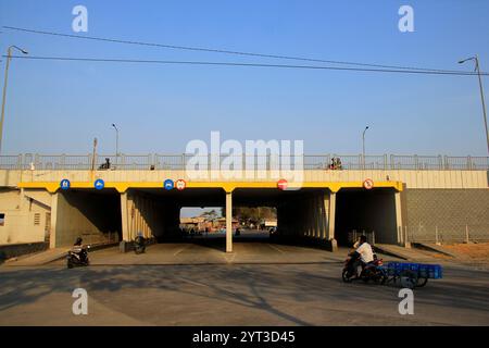 Crossing road or underpass under the flyover to facilitate access for residents Stock Photo