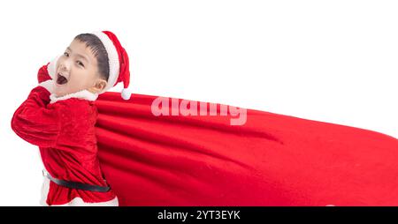 Happy boy  Dressed as Santa Carrying Bag Full of Gifts Stock Photo