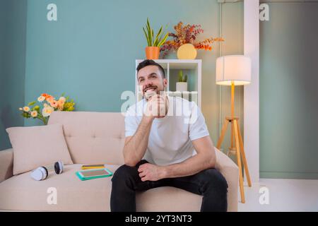 Man thinking in modern living room Stock Photo
